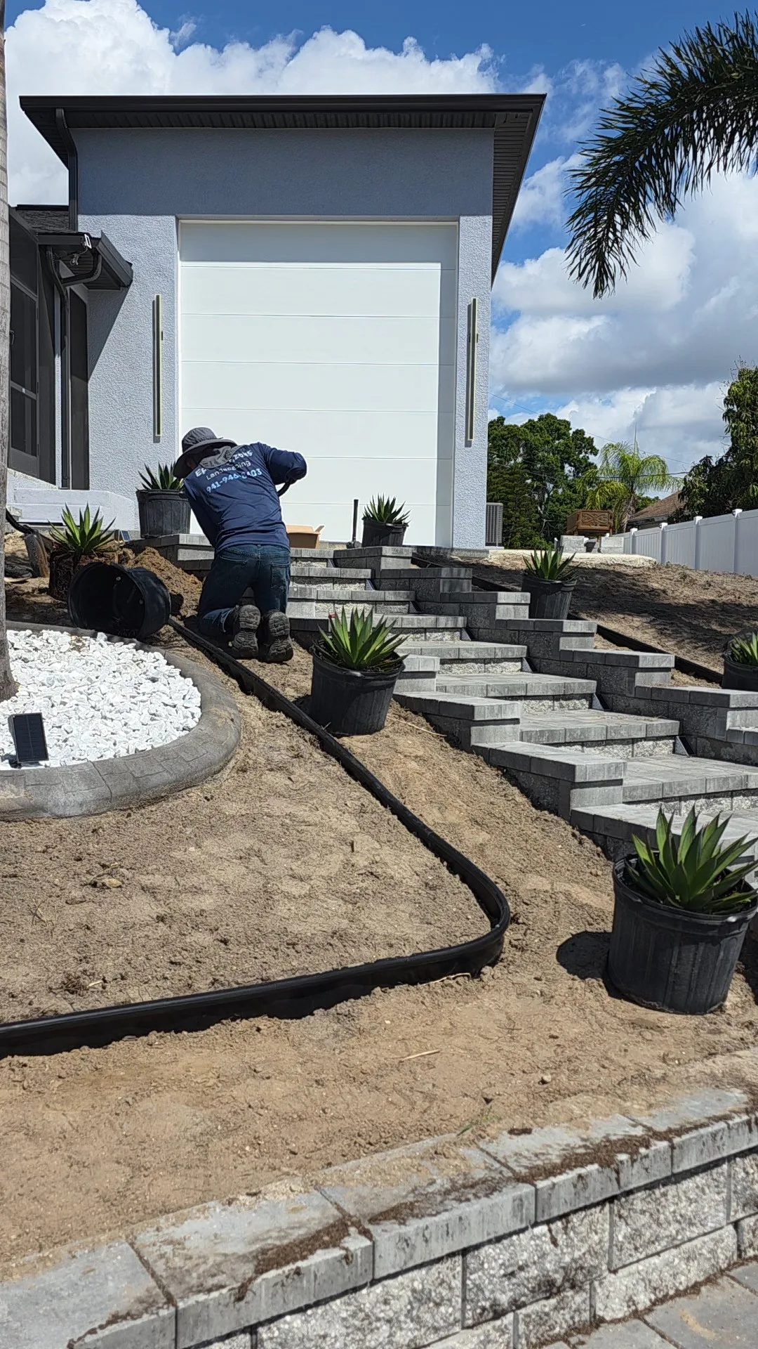 Completed plant beds with 16 varieties, flagstone, and sod