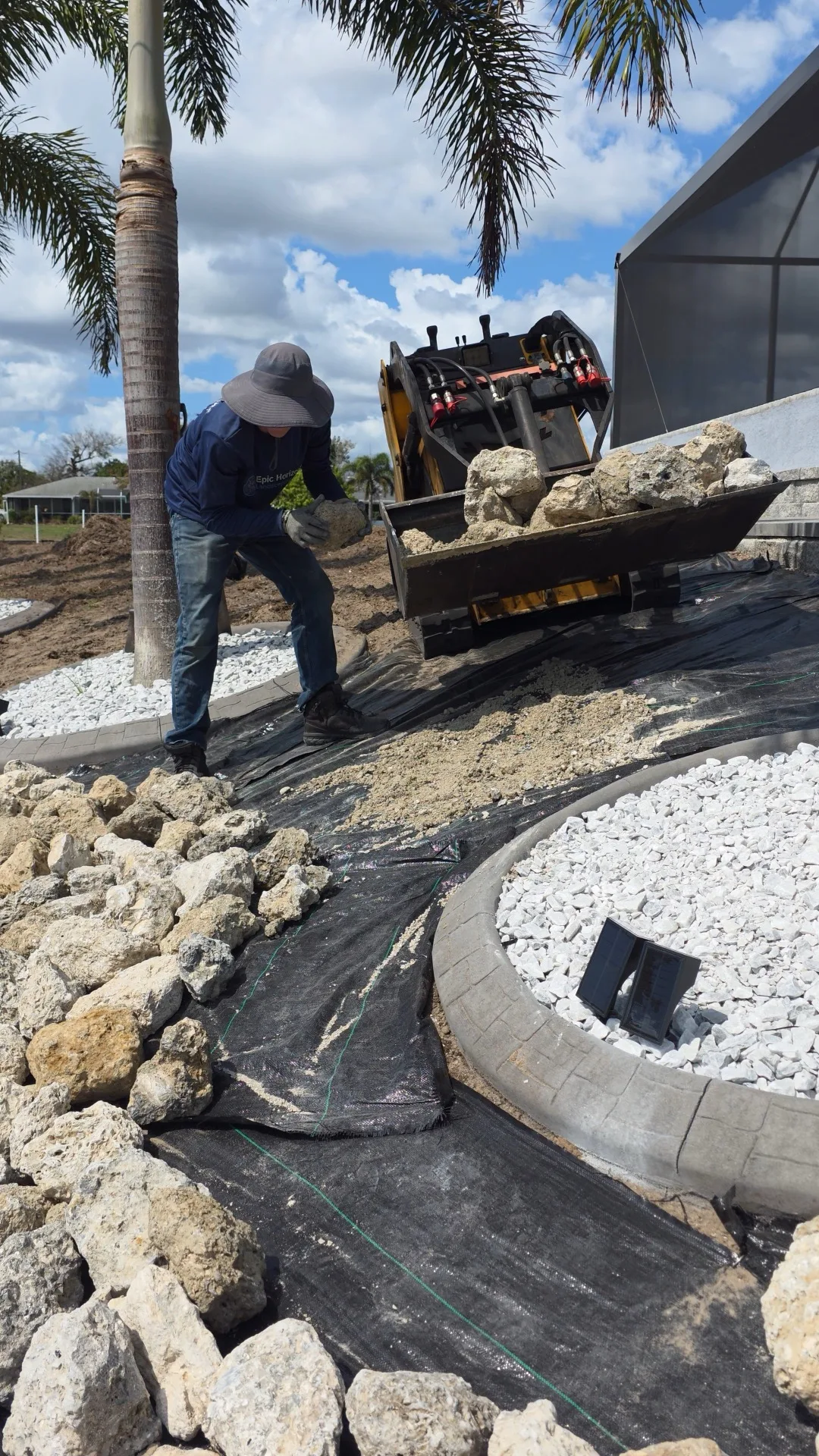 Finished rock mulch landscape with boulders and plants