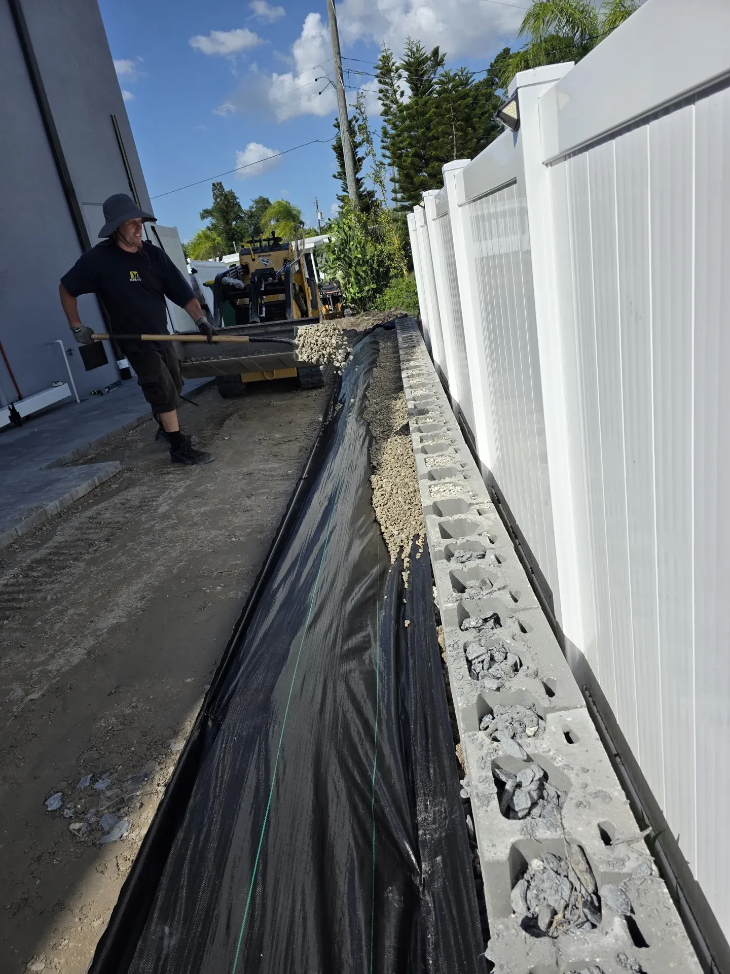 French drain trench with perforated pipe before gravel backfill