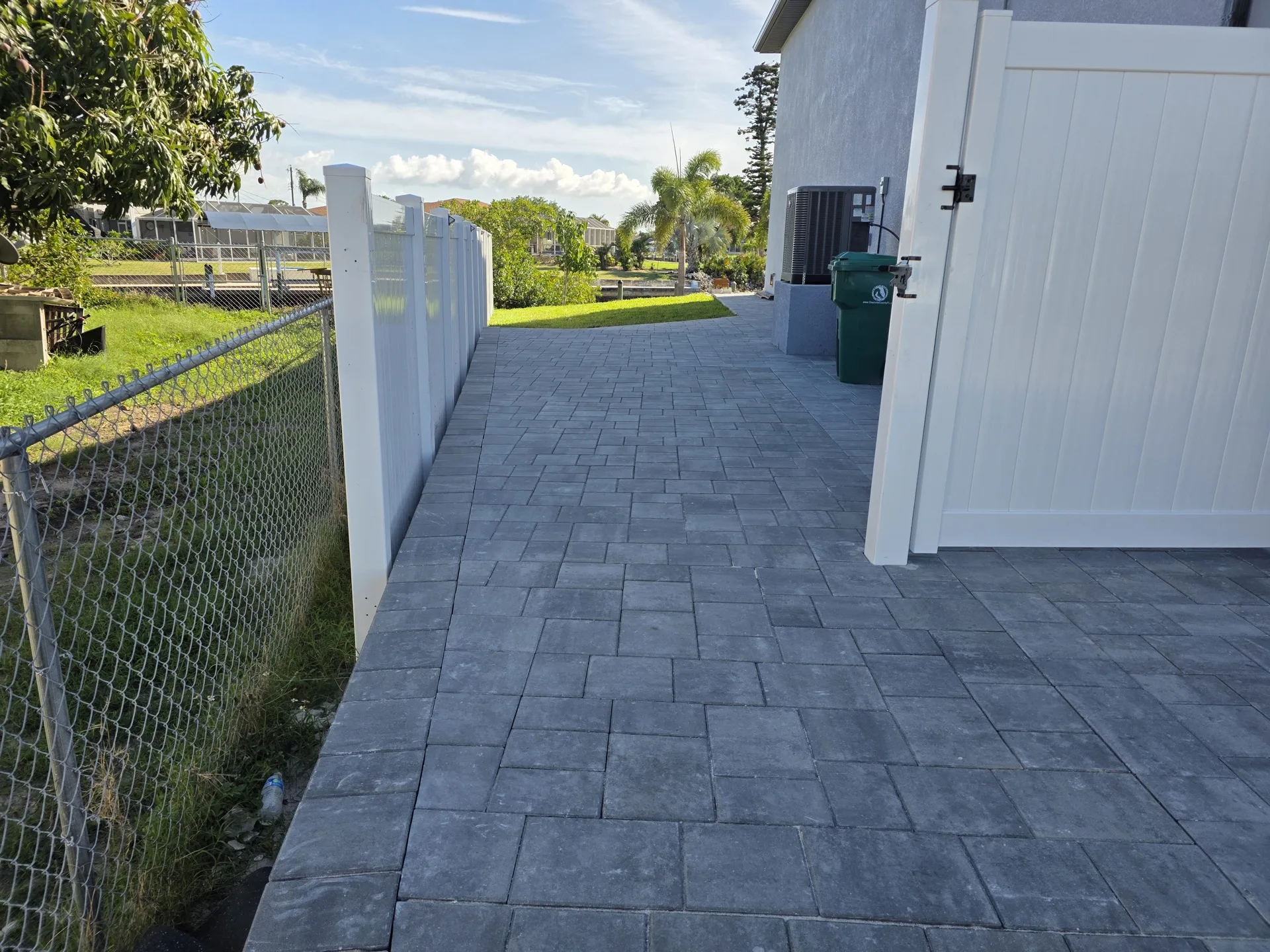 Travertine paver driveway installation in North Port FL replacing cracked concrete with drainage issues