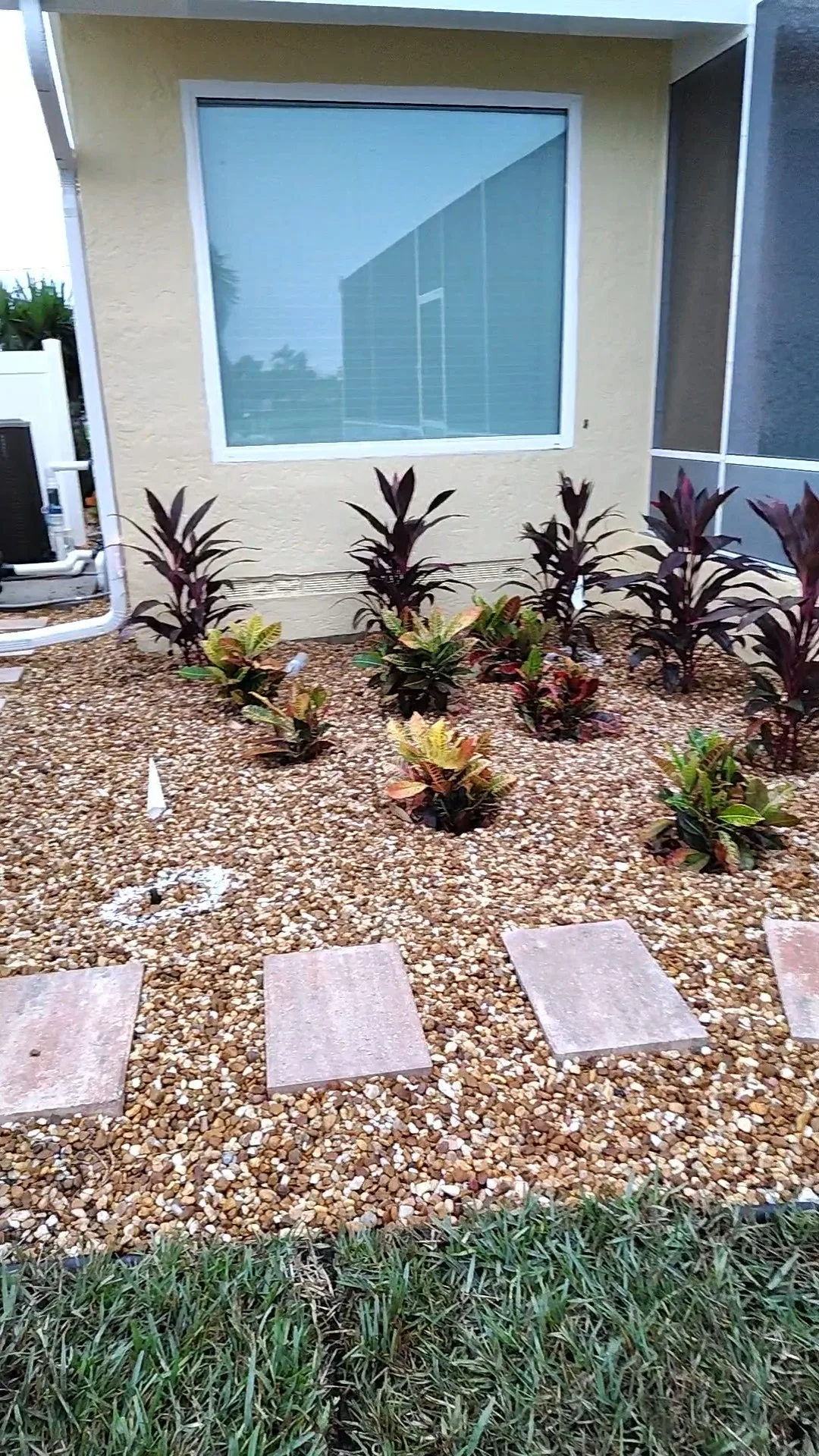 Fresh river rock bed with limestone boulder border and replanted ferns and shrubs