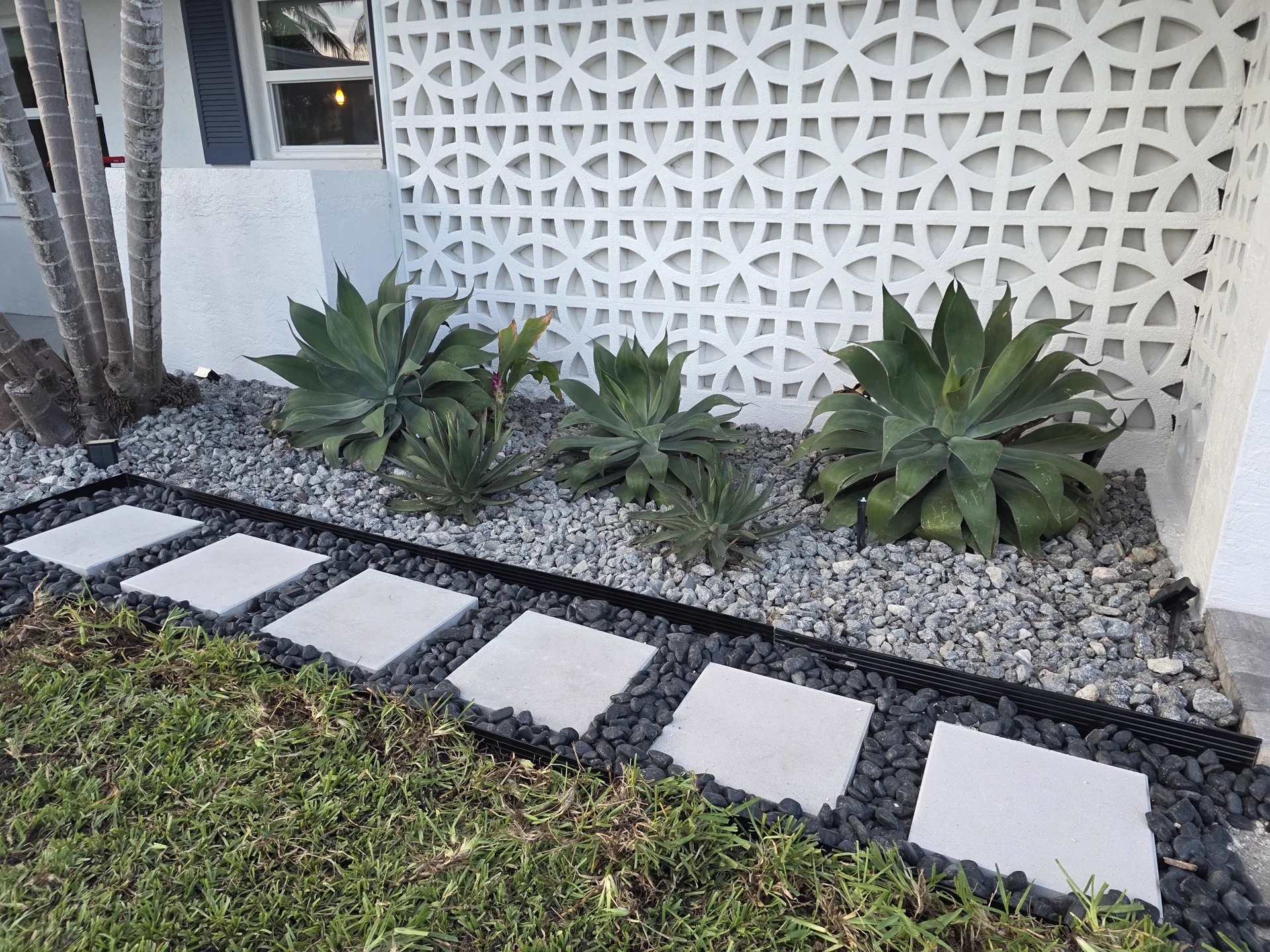 Retaining block wall along front yard grade with fresh sod