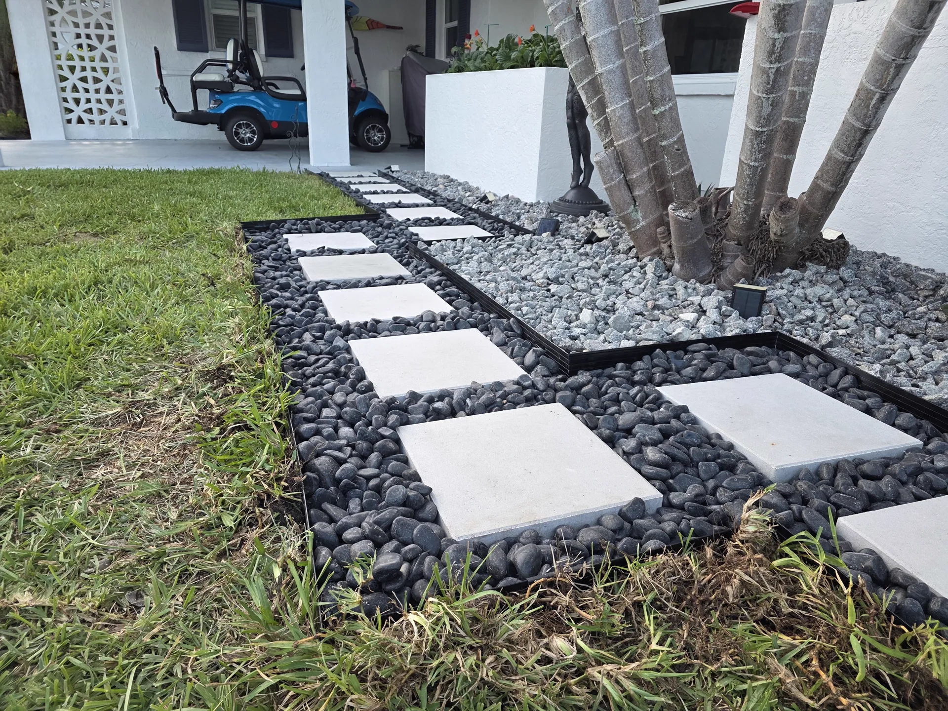 Plate compactor compacting the crushed-stone base before hardscaping