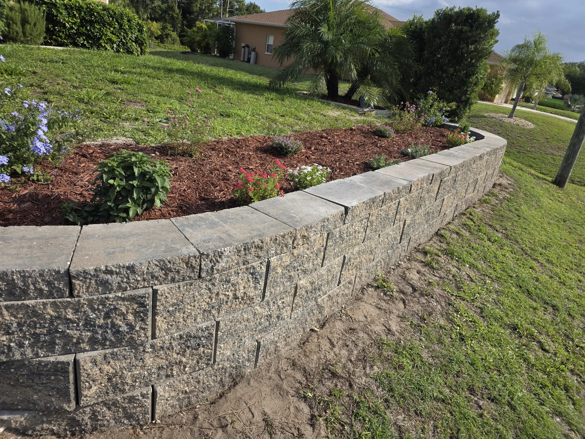 Curved block retaining wall stabilizing an eroding slope in the Myakkahatchee corridor North Port FL