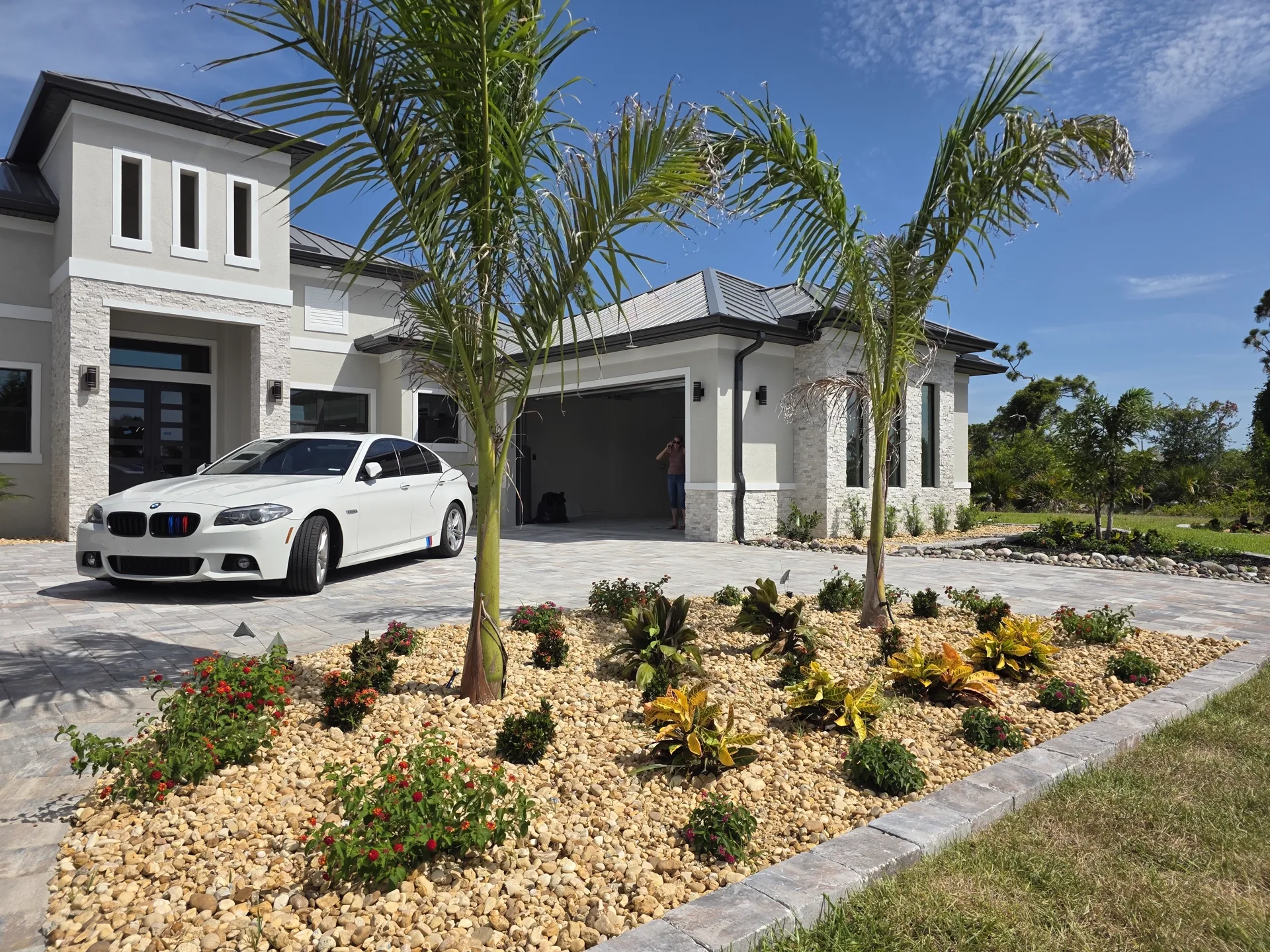 Cluster of palms in a finished mulch bed beside a home — full renovation, Port Charlotte FL