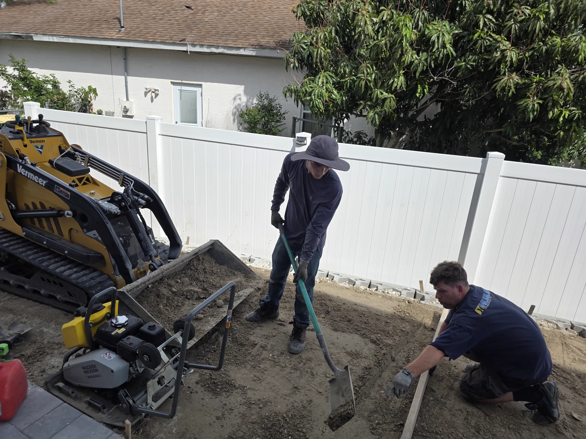 Worker installing pavers in a pattern during installation