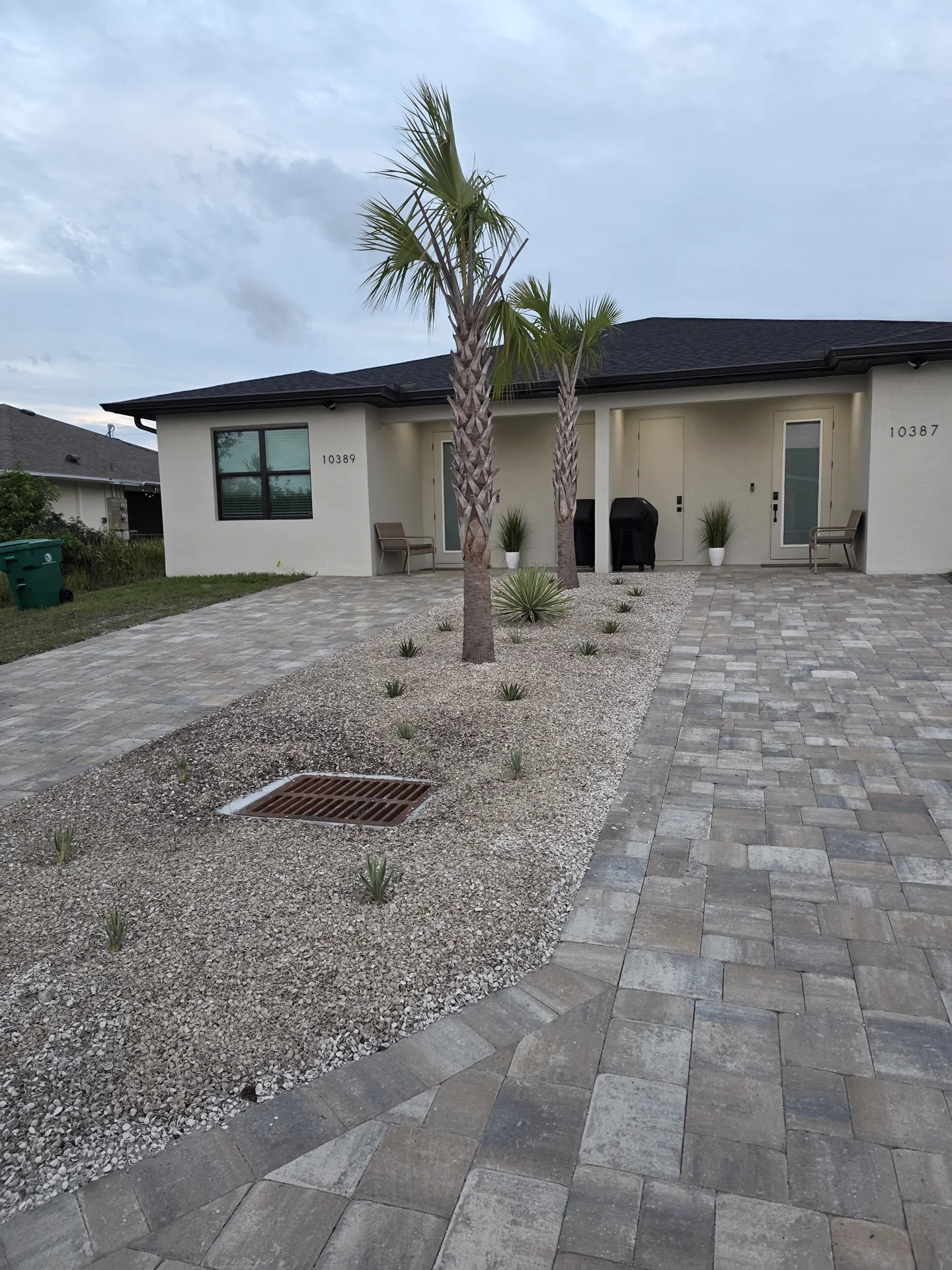 Finished curved paver walkway with mulch beds on both sides