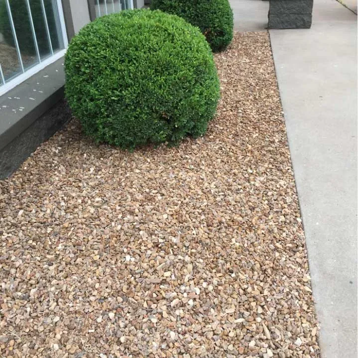 Decorative rock installed in curbed landscape beds in North Port FL