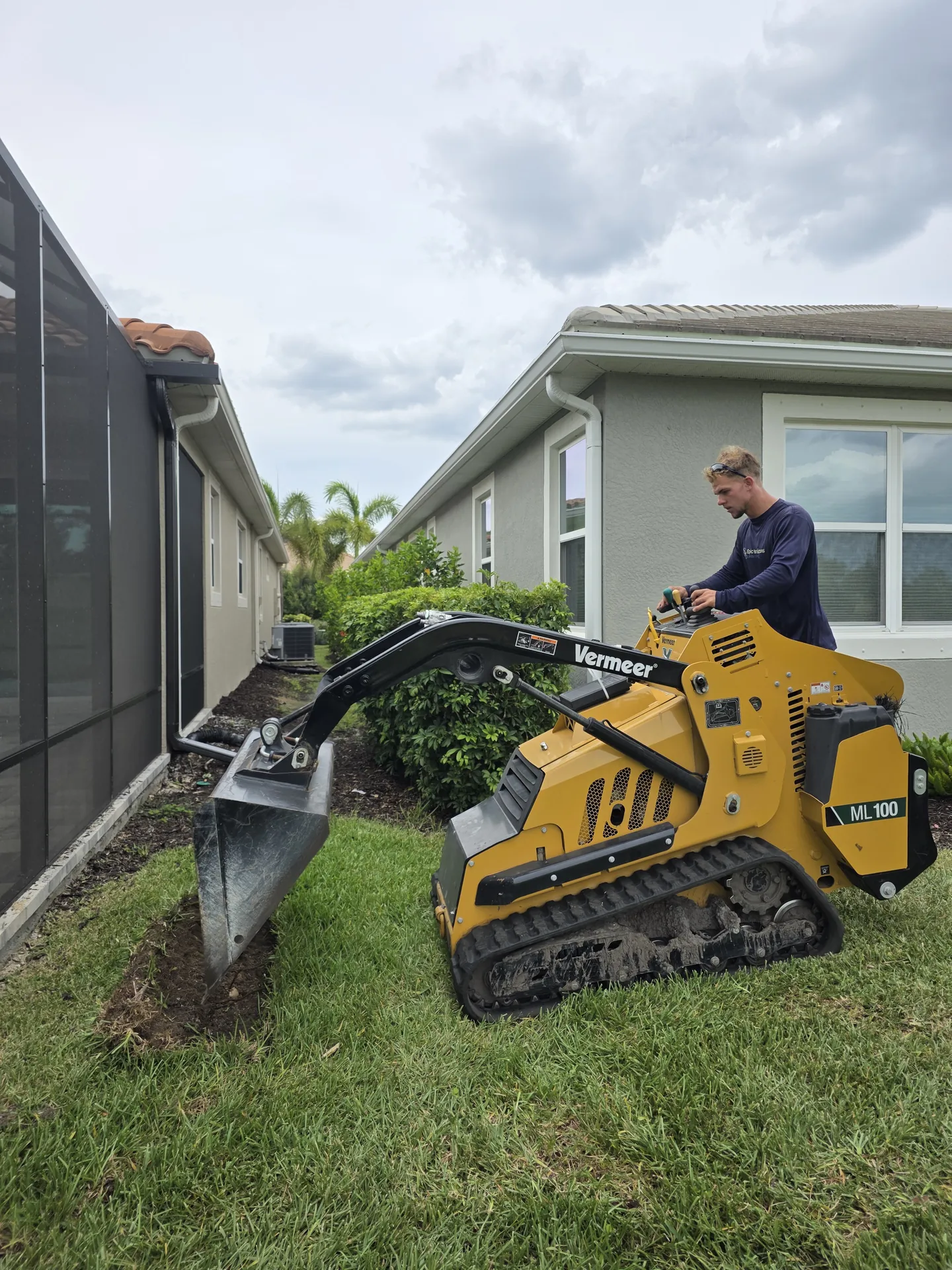 Vermeer mini skid steer track loader working at a job site